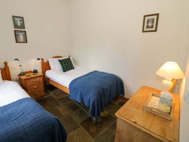 A bedroom with two beds and a chest of drawers at Robbie's Barn Fulready near Stratford-upon-Avon