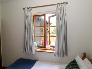 A bedroom with a window and bed at Robbie's Barn Fulready near Stratford-upon-Avon