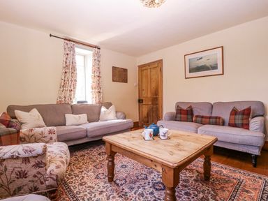 A living room with a coffee table and sofas at Elm View Chipping Campden