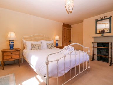 A bedroom with a bed and lamps at Elm View in Chipping Campden