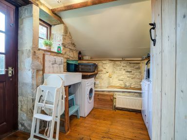 A laundry room with a washing machine and drying rack at Elm View in Chipping Campden