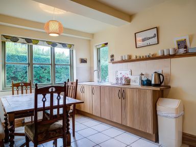 A kitchen with a table and chairs at Elm View in Chipping Campden