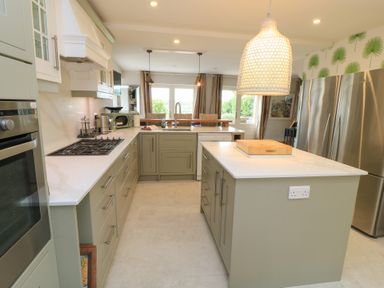 A kitchen with a large island and stainless steel appliances at Fairview Cottage in Milton-Under-Wychwood