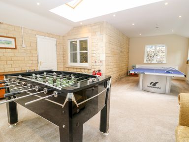 A game room with a foosball table and a table tennis table at South Hill Farmhouse in Stow-On-The-Wold
