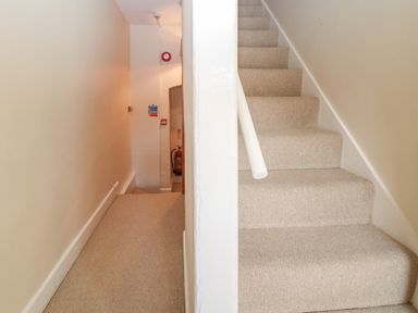 A carpeted staircase and a corridor with a fire extinguisher at South Hill Farmhouse in Stow-On-The-Wold