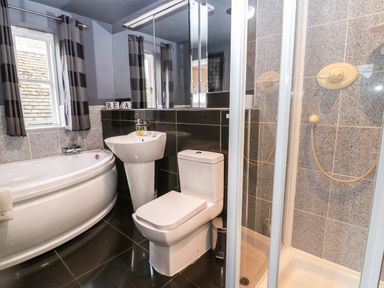 A bathroom with a bathtub sink toilet and shower at South Hill Farmhouse in Stow-On-The-Wold