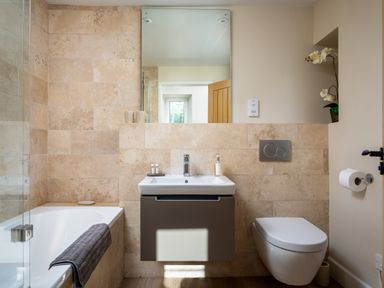 A bathroom with a bathtub sink and toilet at Orchard House in Stow On The Wold