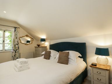A bedroom with a double bed and two nightstands at The Old Reading Room Bledington near Stow-on-the-Wold