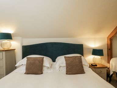 A bedroom with a bed and lamps at The Old Reading Room in Bledington near Stow-on-the-Wold