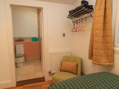 A bathroom with a toilet and towel storage at The Linhay in Little Coxwell near Faringdon