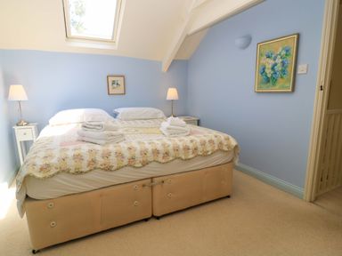 A bedroom with a bed and bedside tables at Cider Press Cottage in Priston Village, Bath