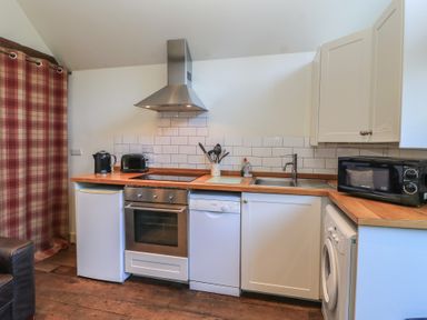 A kitchen with appliances and countertops at Pop's Barn Downton