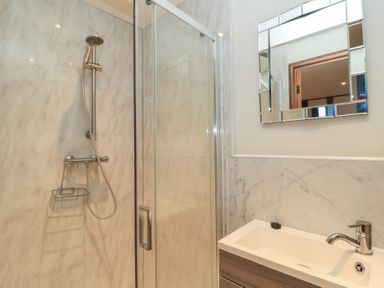 A bathroom with a shower and sink at Pop's Barn in Downton