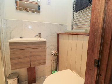 A bathroom with a sink and toilet at Pop's Barn, Downton