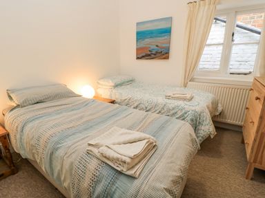 A bedroom with two beds and a painting at Rojoy in Salisbury
