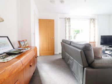 A living room with a sofa and television at Arnant in Dolgellau