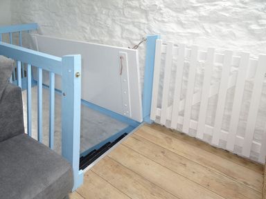 A staircase with blue and white railings and wooden floor at Anchorage in Watchet
