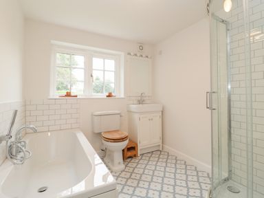 A bathroom with a bathtub toilet sink and a glass shower at Church View in Salisbury