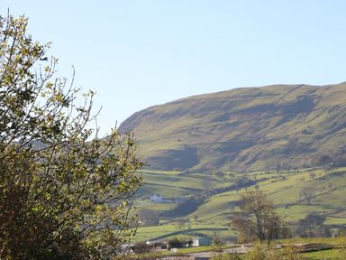 A landscape with hills trees and a few houses at Cranny Corner in Carnlough