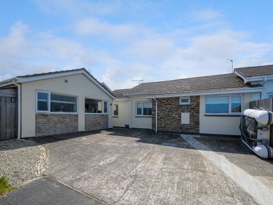 A driveway in front of a single story house with stone and cream walls at Coastal Haven in Crackington near Crackington Haven