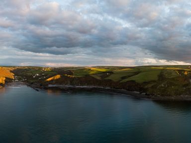 A coastal landscape with cliffs and green fields near the sea at Coastal Haven in Crackington near Crackington Haven