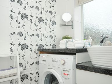 A laundry room with washing machine towels and a sink at Coastal Haven in Crackington near Crackington Haven