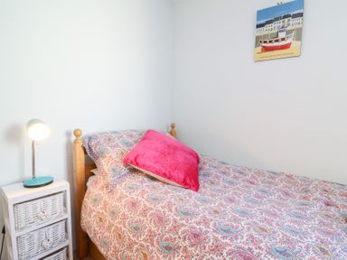 A bedroom with a bed and lamp at Willets Cottage Appledore