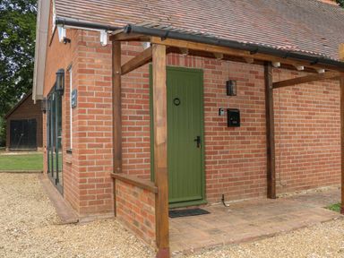 A porch with a green door and a mailbox on a brick house at Thames Reach in Wallingford
