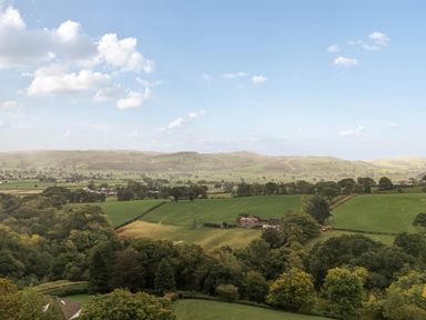 A view of fields and hills at Ty Berllan in Caersws