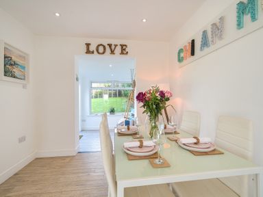 A dining room with a table set for dinner at Chi An Mor in Porth