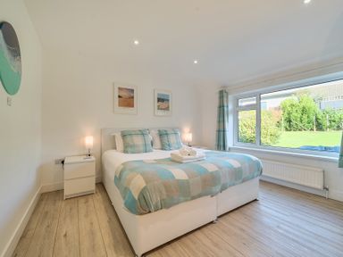 A bedroom with a double bed and outdoor view at Chi An Mor in Porth