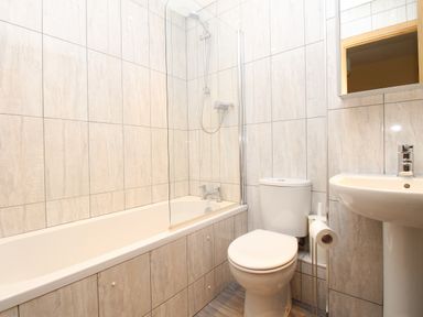 A bathroom with a bathtub shower toilet sink and mirror at Anvil House Brewers Quay Harbour