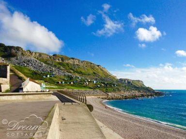 A coastal path with a beach and rocky cliffs by the sea at Beach View Apartment 2 in Greenhill