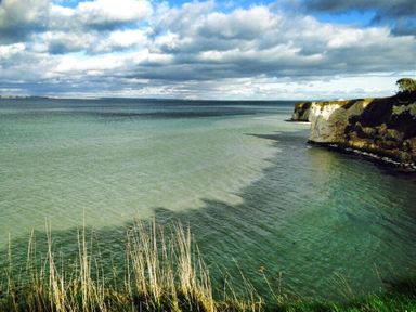 A coastal landscape with water cliffs and clouds at Coombe Orchard Swanage