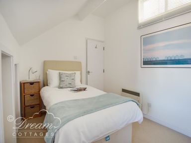 A bedroom with a bed a bedside table with lamp and a framed picture on the wall at Dream View in Greenhill
