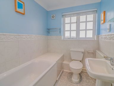 A bathroom with a bathtub toilet and sink at Hops House Brewers Quay Harbour