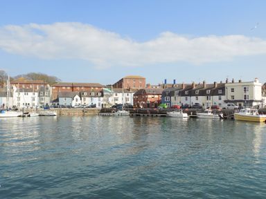 A harbor with boats docked and buildings along the waterfront at Brewers Quay Harbour