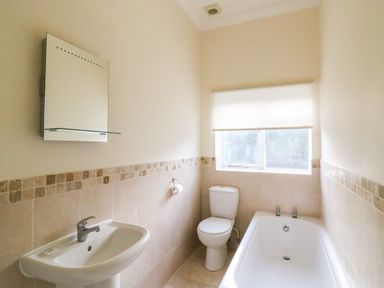 A bathroom with a sink mirror toilet and bathtub at Harbour Watch Apartment 6 Brewers Quay Harbour