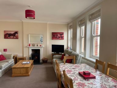 A living room with a sofa and dining table at Mutiny House in Brewers Quay Harbour