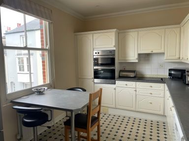 A kitchen with a table and chairs at Mutiny House in Brewers Quay Harbour