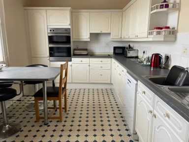 A kitchen with cabinets and appliances at Mutiny House Brewers Quay Harbour