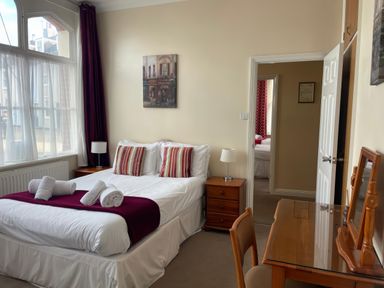A bedroom with a bed and desk at Mutiny House in Brewers Quay Harbour