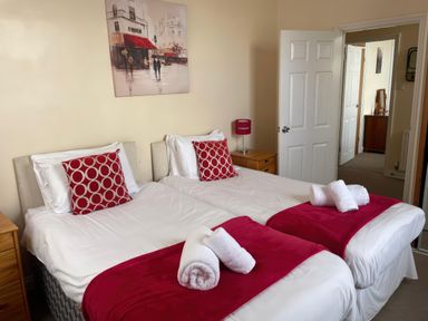 A bedroom with two beds and a painting at Mutiny House Brewers Quay Harbour