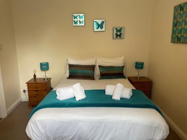 A bedroom with a bed and nightstands at Mutiny House in Brewers Quay Harbour