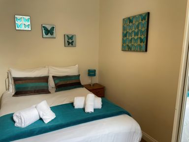 A bedroom with a bed and decorative wall art at Mutiny House in Brewers Quay Harbour