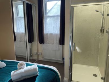A bedroom with a bed and shower at Mutiny House Brewers Quay Harbour