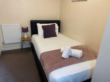A bedroom with a single bed and bedside table at Mutiny House in Brewers Quay Harbour