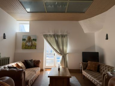 A living room with a sofa and coffee table at The Oast House in Brewers Quay Harbour