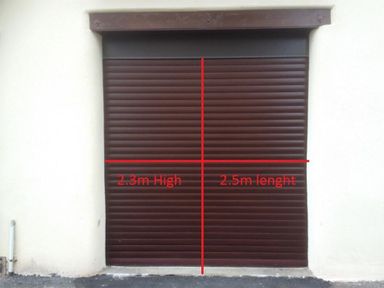 A brown roller shutter door with measurements 2.3 meters high and 2.5 meters length at The Old Boathouse in Weymouth