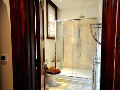 A bathroom with a toilet and a glass shower enclosure at The Old Portland Courthouse in Portland